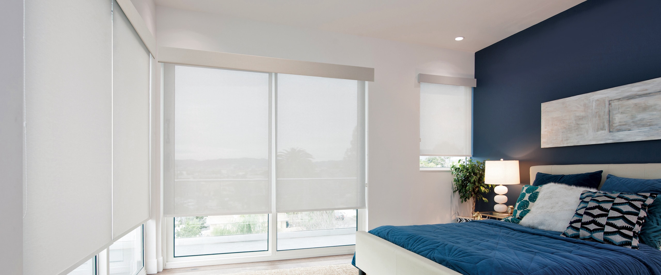 norman soluna roller shades bedroom with blue bedsheet