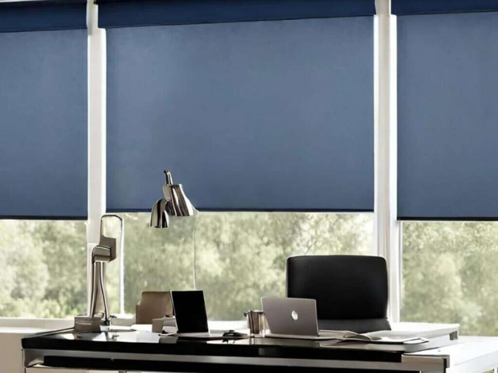 navy automated window shades in an office with a laptop