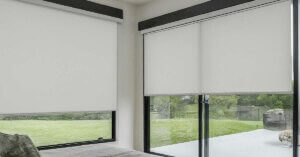 Sliding glass door with sleek roller shades.